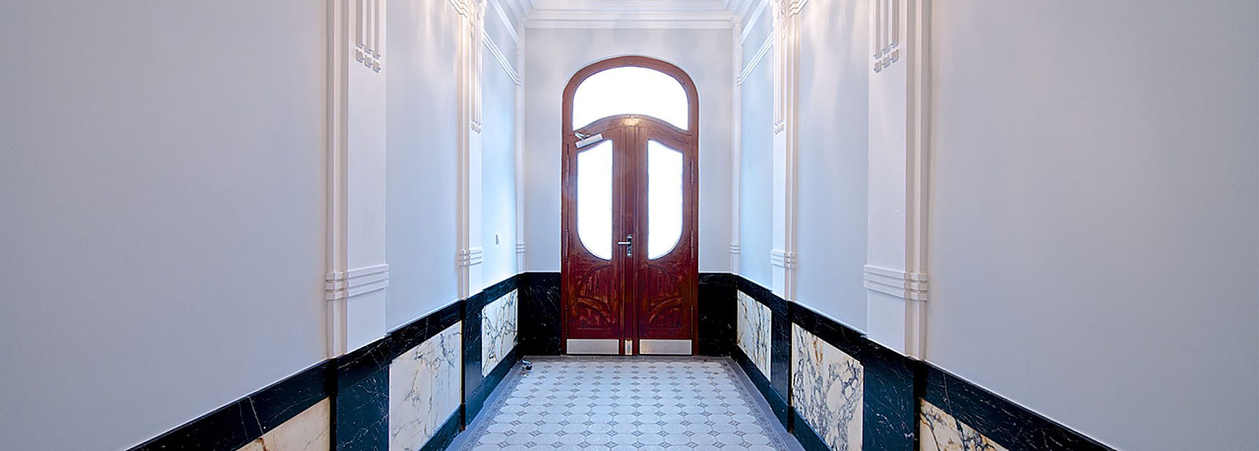 Entrance hall with marble dado and arched door, Berlin Altbau